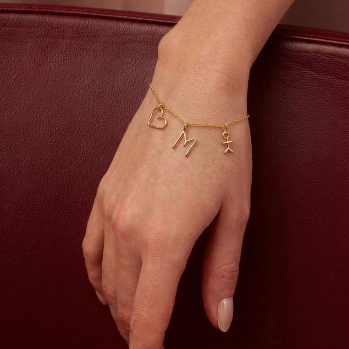 Trio Family Charms Bracelet in 14k yellow gold-filled wire, worn on a woman's wrist
