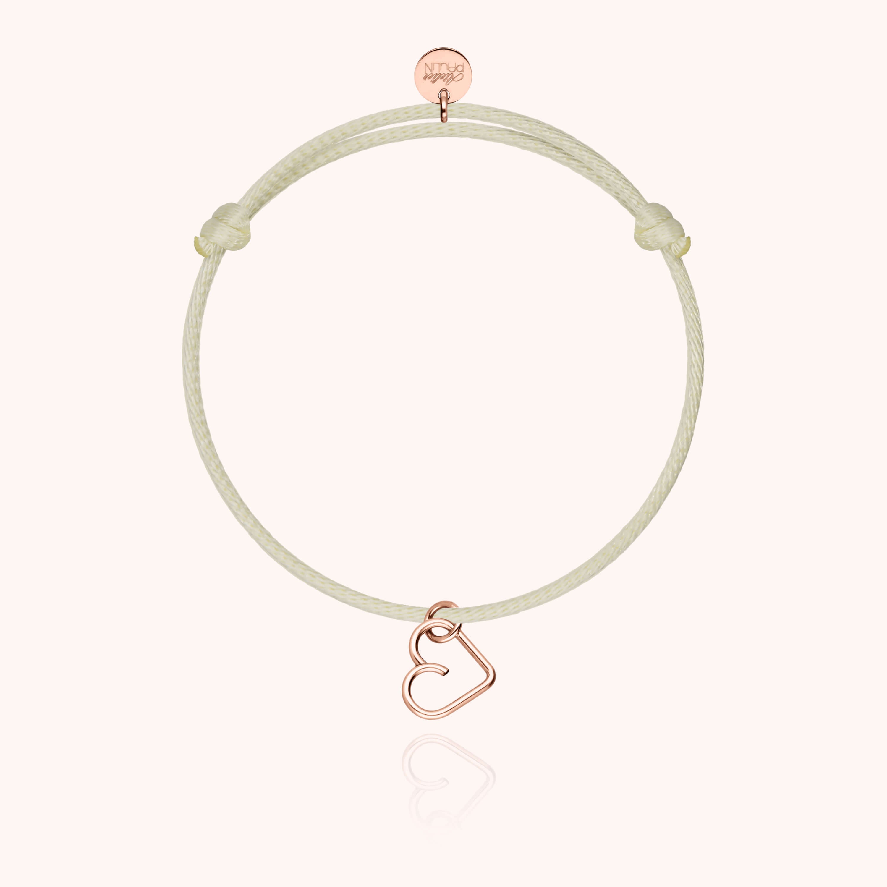 Cordon synthétique ajustable et charm cœur or rose détaillé