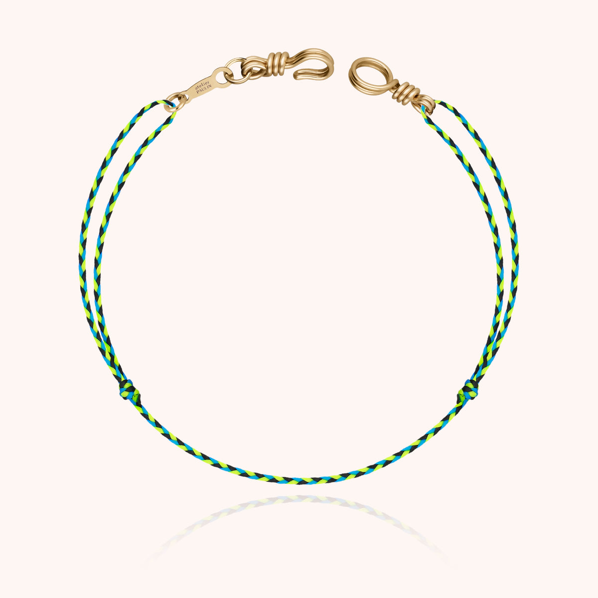 Detail of the 14k gold-filled wire clasp on a green cord