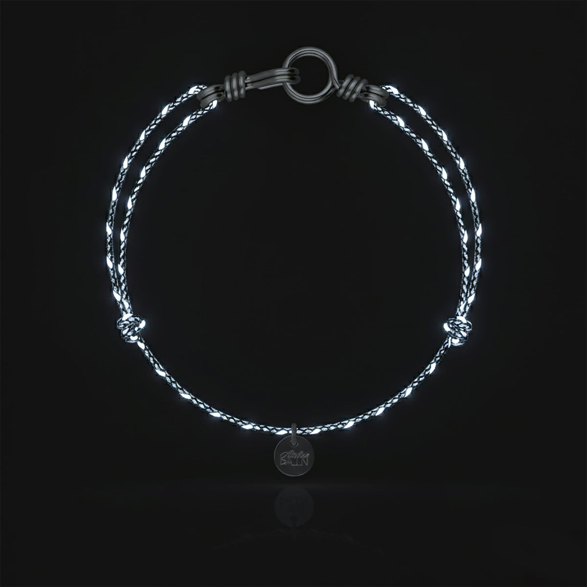 Close-up of the clasp on the Reflective Cord Bracelet Attache moi in sterling silver wire