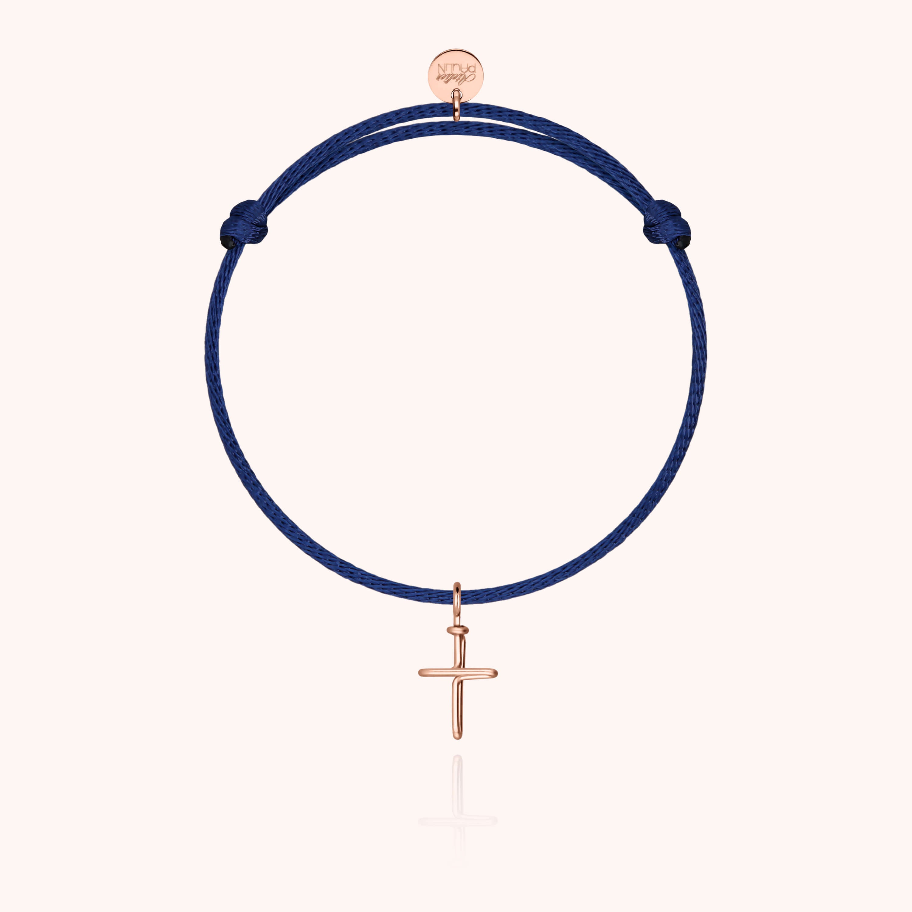 Bracelet cordon enfant avec croix en or rose laminé sur fond blanc