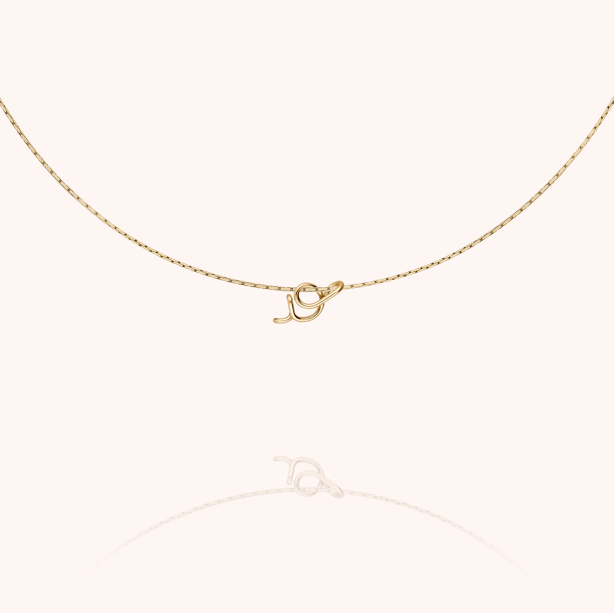 Original Initiale Necklace, worn around the neck