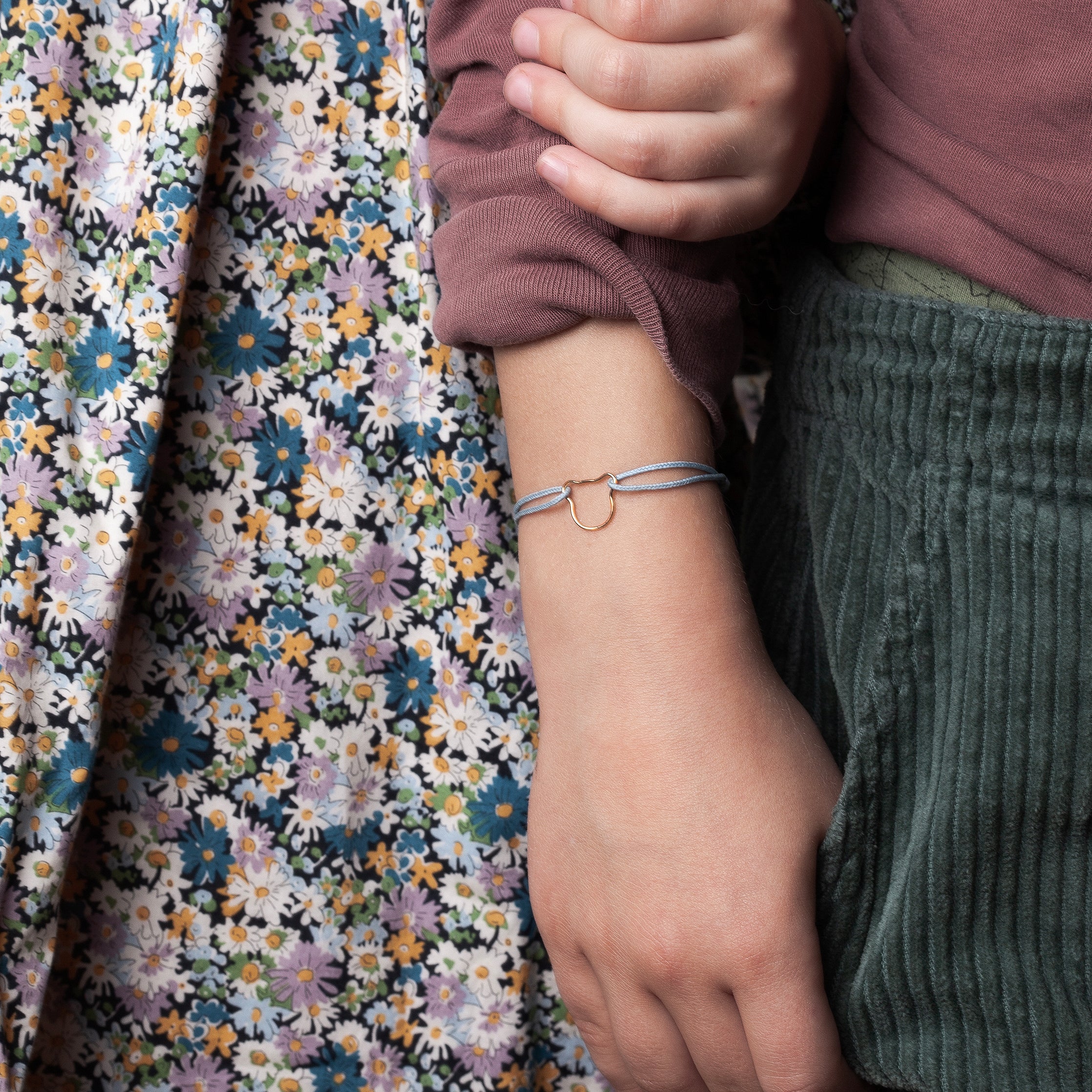 Gros plan sur le système de nœuds coulissants du cordon rose pâle