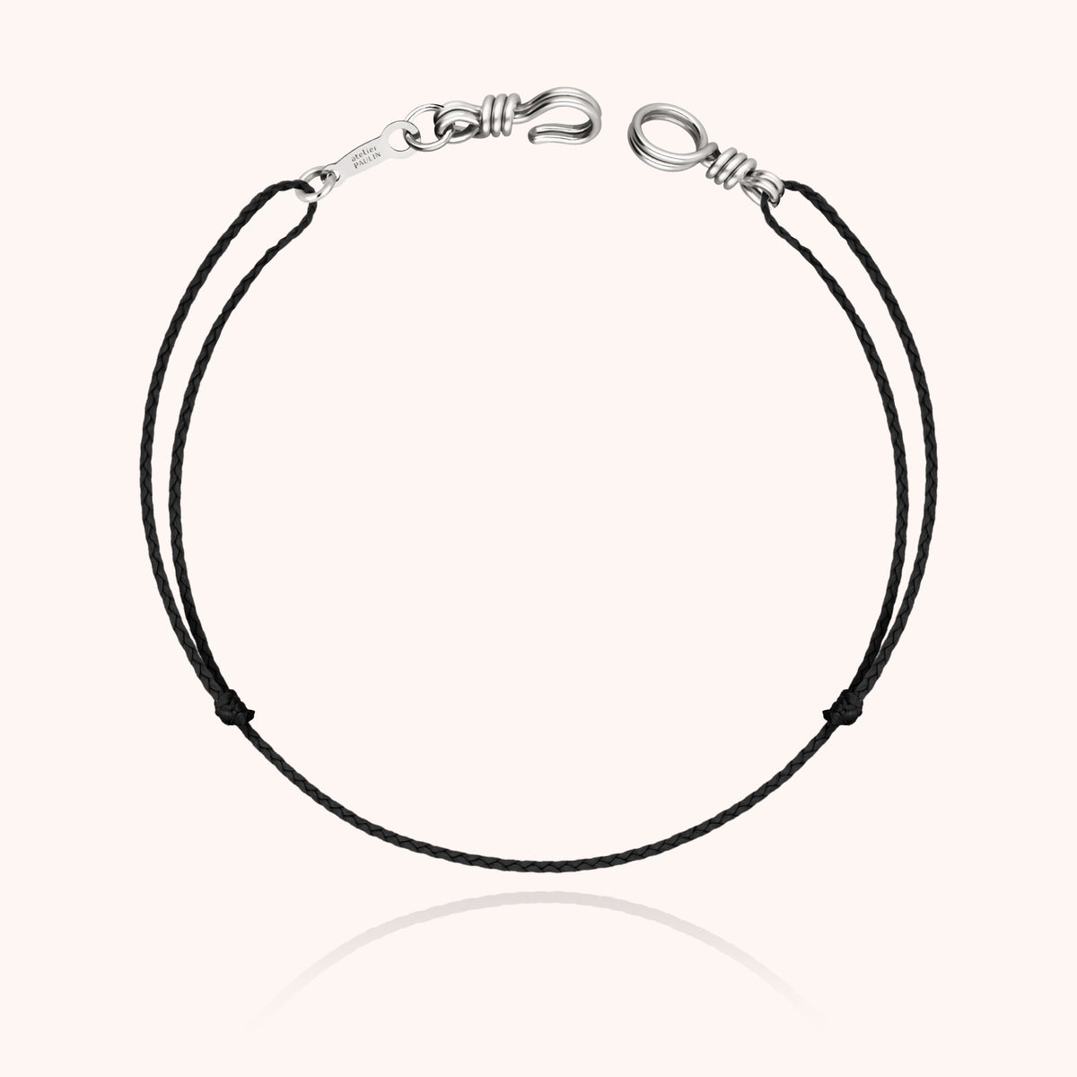 Close-up view of the hand-shaping in 18k white gold wire