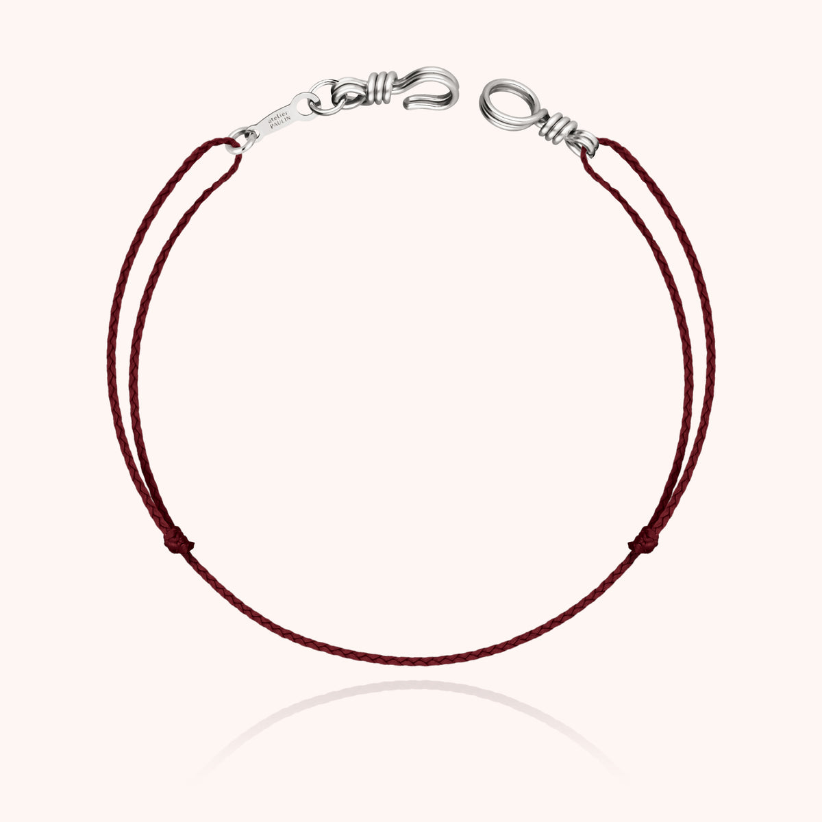 Cord Bracelet Mini Attache moi in 18k white gold wire with its mini clasp on a colored cord