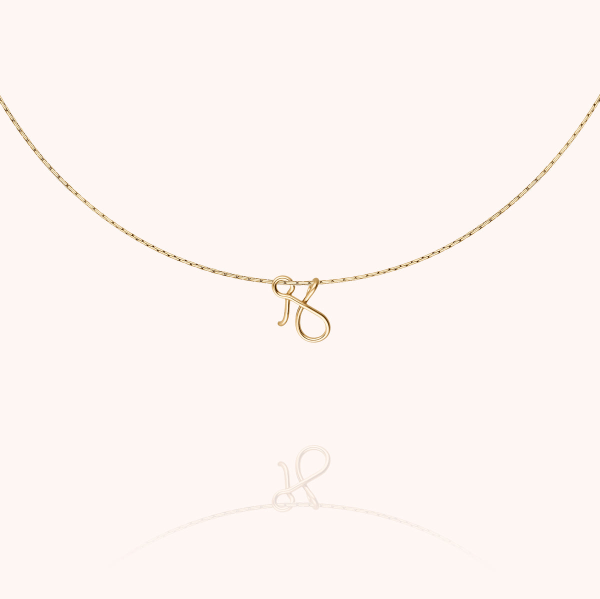 Original Initiale Necklace, worn around the neck